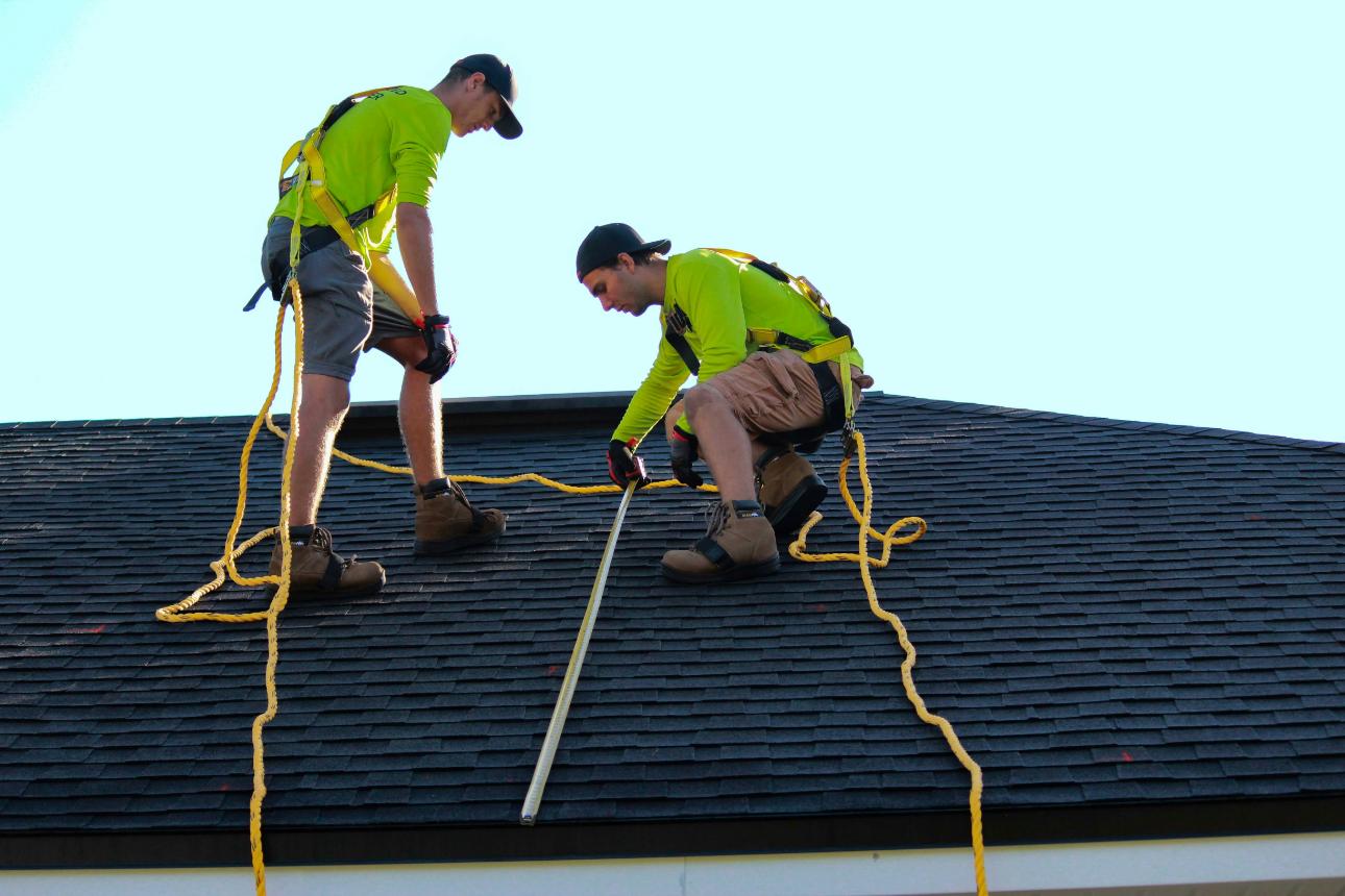 Roofers working on a house