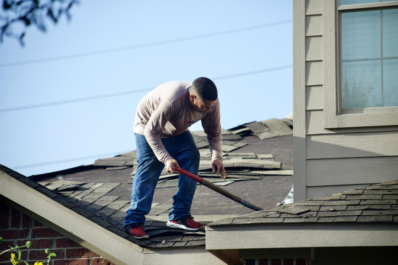 Person repairing a roof